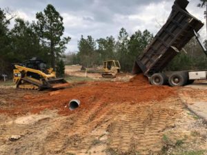 JWHIT Construction, LLC in Huntsville, TX - Image of JWhit Construction' vehicle working on a land